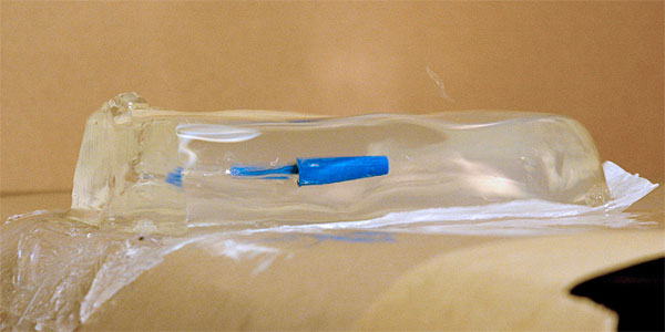 The projectile from the Rubber TEC as it just has stopped in the middle of the gel. The shockwave reflections are still visible.