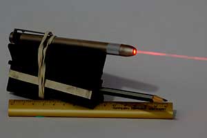The Super Maul with a laser pen mounted and laser turned on. The red laser beam is visible.