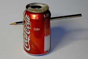 An empty coke can with a pencil shot through it.